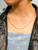 Model wearing 19-20 inch natural freshwater seed rice pearl necklace draped below collarbone
