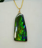 Authentic Canadian Ammolite pendant necklace in 14K gold filled, showcasing a vibrant green spectrum gemstone.