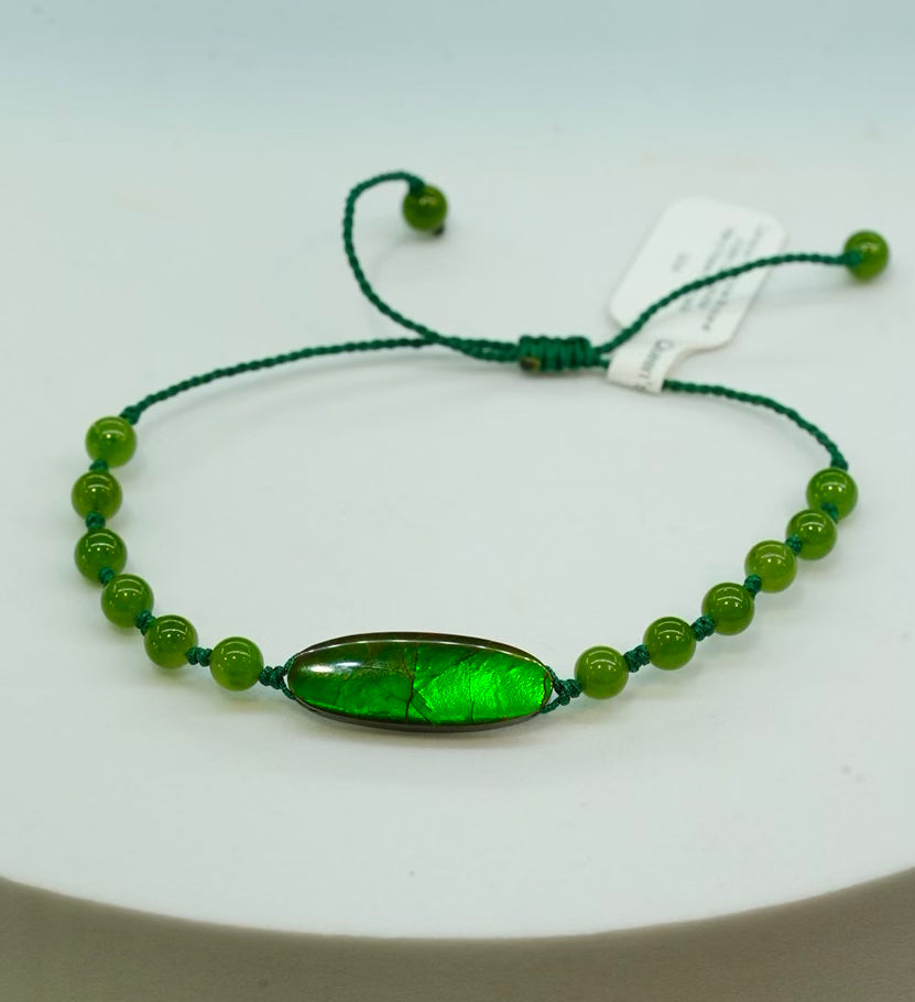 Handcrafted Ammolite gemstone bracelet featuring an iridescent green and blue doublet stone on an adjustable cord.