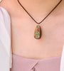Model wearing a whole-piece Canadian Ammolite pendant necklace with 14k gold-filled settings