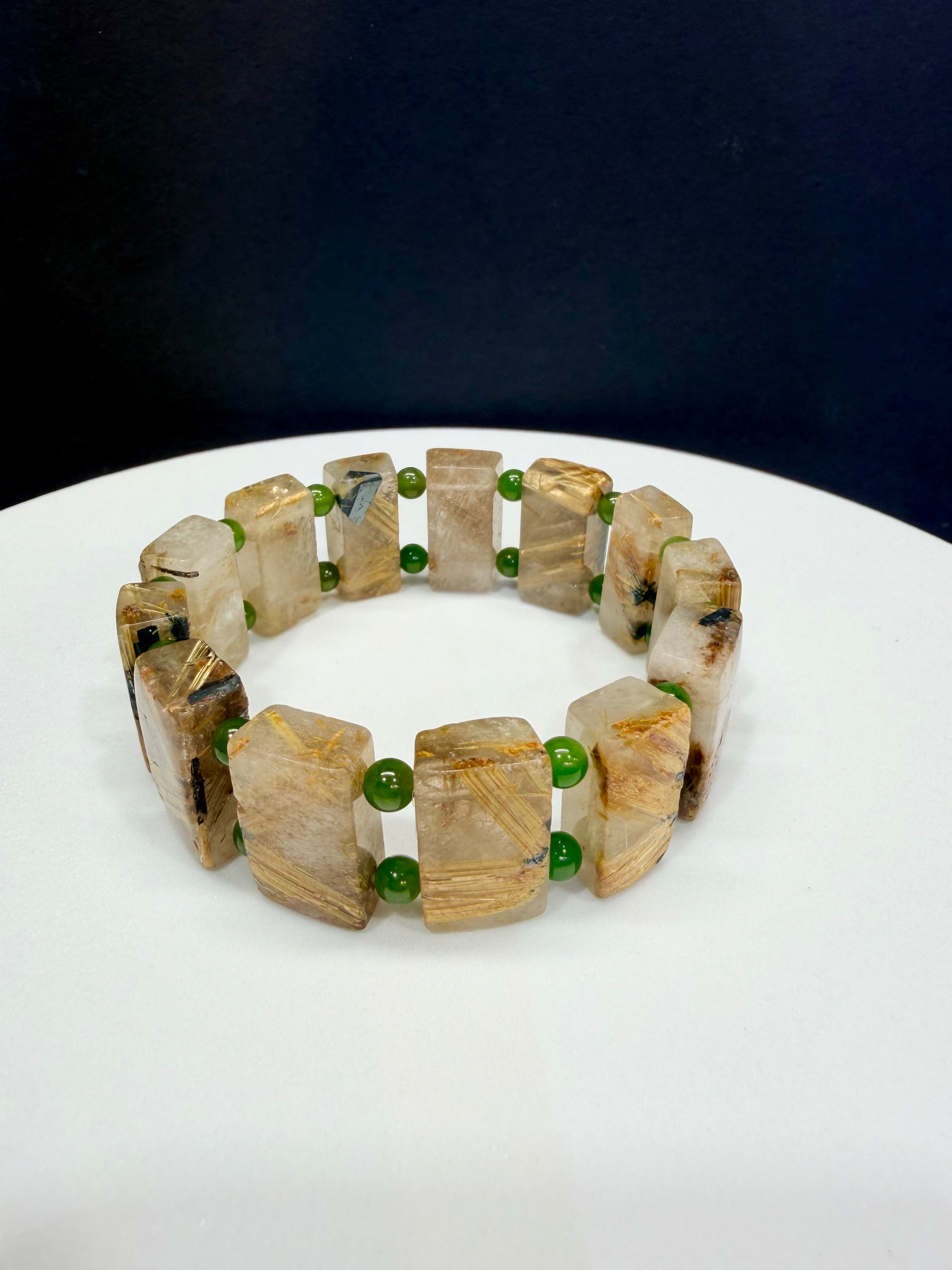 Queen's Gems gold rutilated quartz and nephrite jade handmade beaded plaque bracelet, photographed in Markham, Ontario.