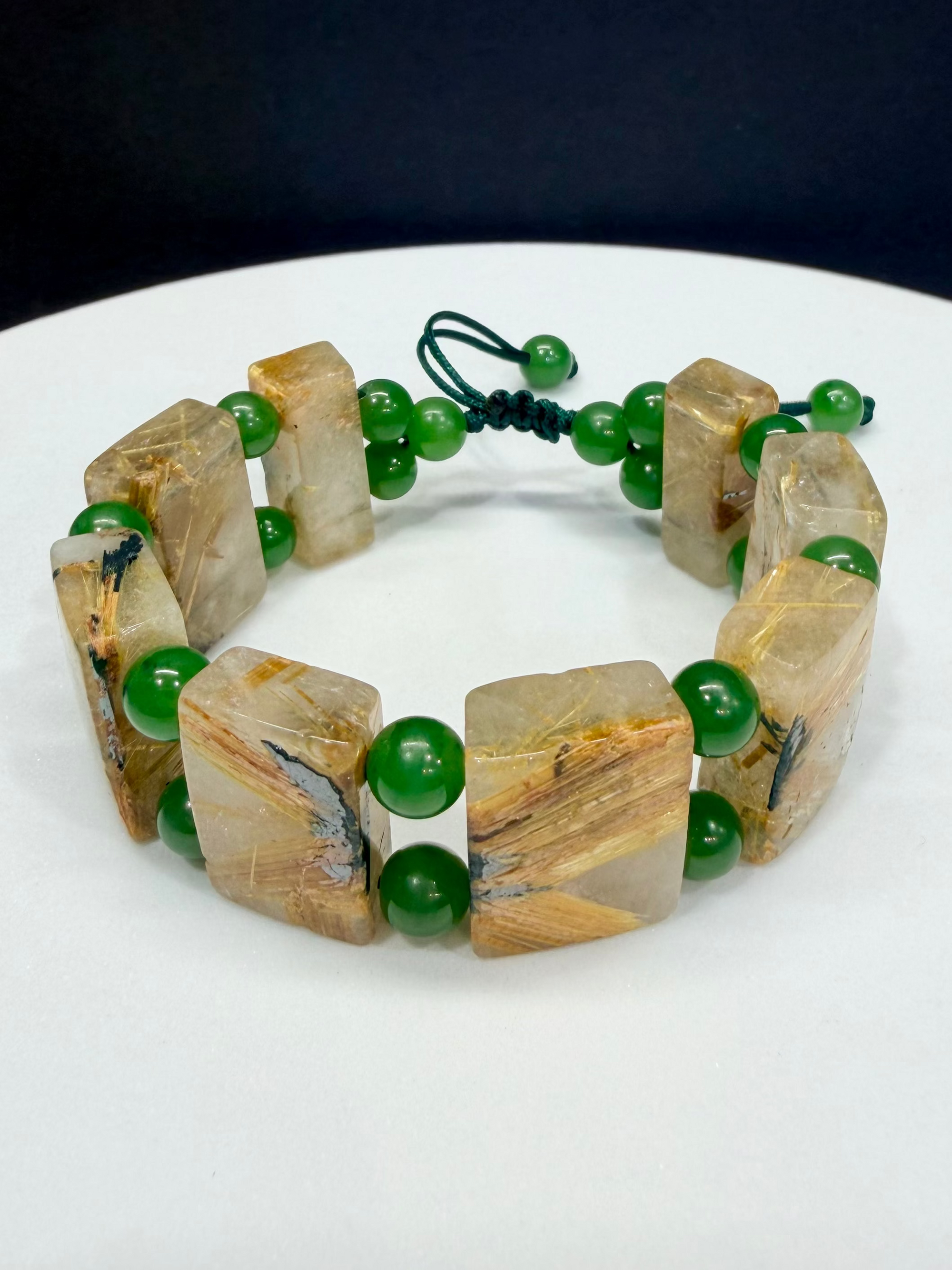 Handmade Gold Rutilated Quartz and Nephrite Jade beaded bracelet by Natural Gems Canada, showing genuine golden titanium crystal inclusions. Natural Gems Canada 手工天然金发晶和田玉碧玉手串，展现清晰的钛晶猫眼发丝。