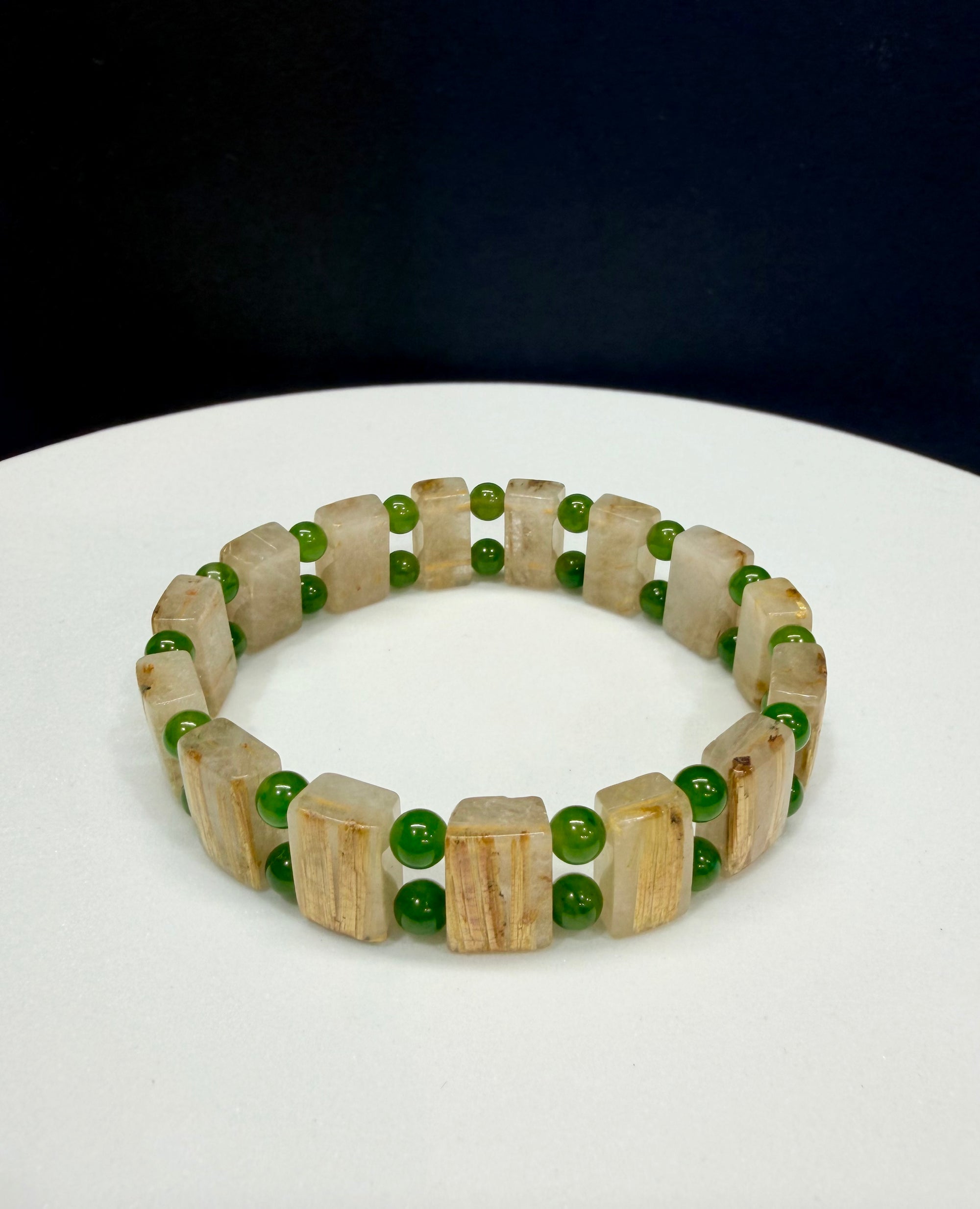 Rutilated vertical gold quartz with jade beads into a handmade bracelet