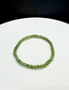 Canadian Arctic Polar jade beaded bracelet with 4mm green jade beads on a white surface with a black background.