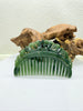 Green double phoenix nephrite polar jade hair comb with intricate carvings on a white background