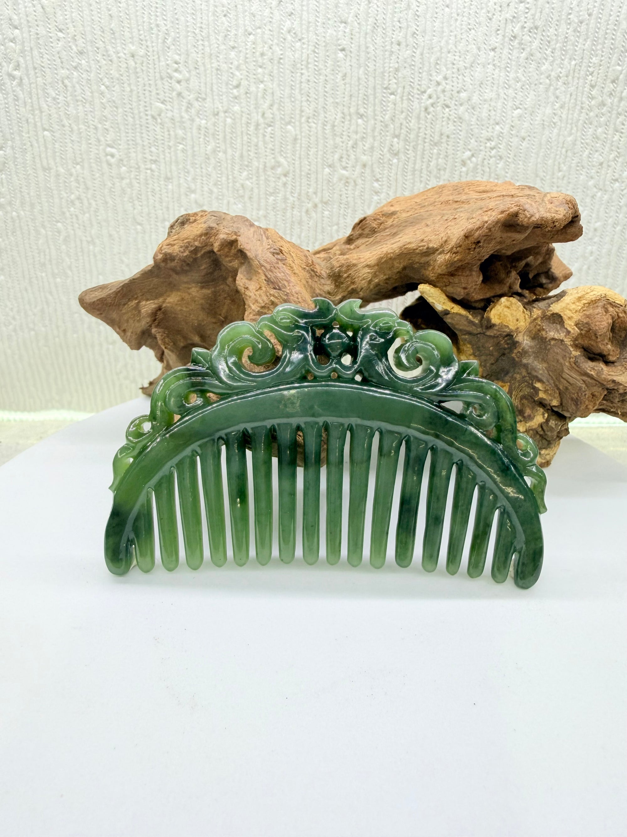 Green double phoenix nephrite polar jade hair comb with intricate carvings on a white background