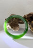 Premium 58mm Siberian flawless green chatoyant jade bangle displaying a sharp natural cat's eye line. 天然西伯利亚罕见绿猫眼碧玉手镯。