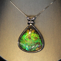 Whole piece of Canadian ammolite stone. Color changing from yellow, green, bluish green to blue, high flash coloration.